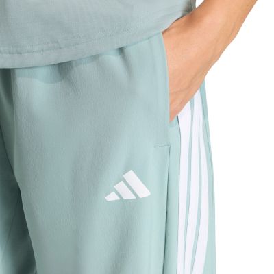 4. Spodnie damskie adidas Workout Essentials 3-Stripes Woven miętowe KC5494